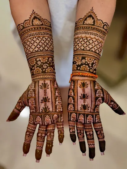 A full view of Jasleen's festive mehendi, showing the detailed work on both hands.