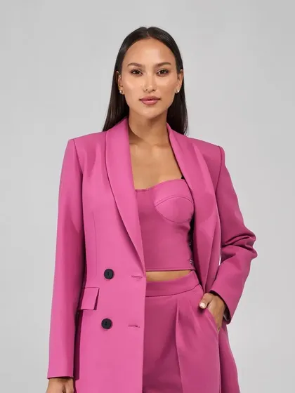 This vibrant hot pink suit is for the woman who isn't afraid of color. It’s a double-breasted design with a slightly oversized blazer and matching trousers, perfect for making a statement.