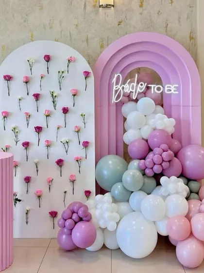 For the modern bride-to-be, we design chic and elegant bridal showers. This setup features a beautiful flower wall, a trendy arch backdrop with a custom neon sign, and a soft pastel balloon arrangement for a picture-perfect party.