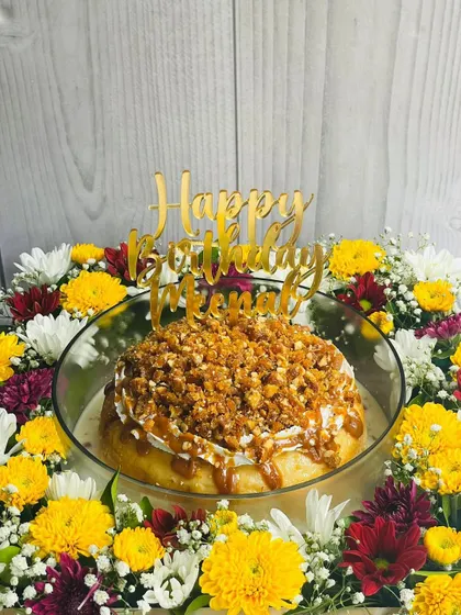 A birthday celebration featuring my Butterscotch Caramel Tres Leches. This cake has a moist sponge soaked in rich butterscotch caramel and is topped with a generous amount of crunchy almond praline.