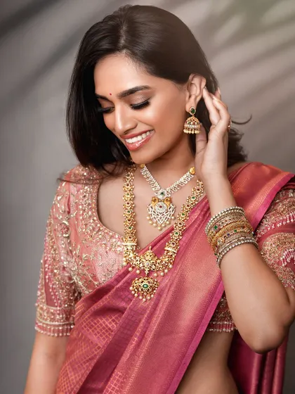 A candid-style bridal shot that captures a moment of joy. This approach brings a natural and relatable feel to bridal lookbooks, highlighting the beauty of the attire in a more personal way.