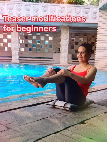 This image shows a modification for the Teaser, a challenging core exercise. Learning how to adapt exercises for beginners is a critical skill for any instructor.