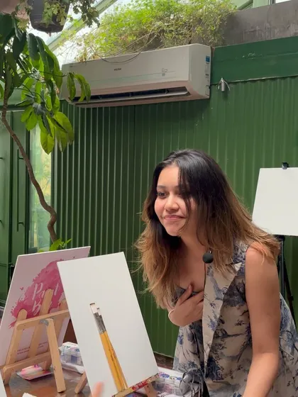 A candid moment of me checking on a participant's painting. I love interacting with everyone and helping them through their creative process.