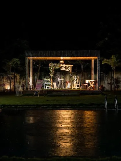 An intimate 25th birthday celebration set against a rustic poolside backdrop. The warm lighting reflecting on the water, combined with personalized decor and lush florals, created a romantic and truly special ambiance for this milestone evening.