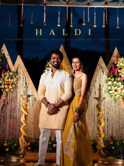 A classic Haldi portrait of the couple against a stunning marigold backdrop, perfectly capturing the theme of the golden touch of love.