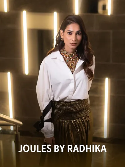 The talented Aneri Vajani looking chic and modern, styling a bold, multi-gemstone statement necklace with a classic white shirt.