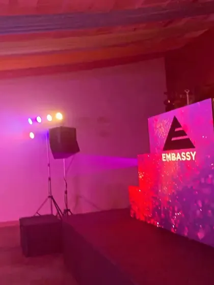 The DJ console and stage setup for an Embassy event. The shimmering backdrop was perfect for a glamorous wedding party.