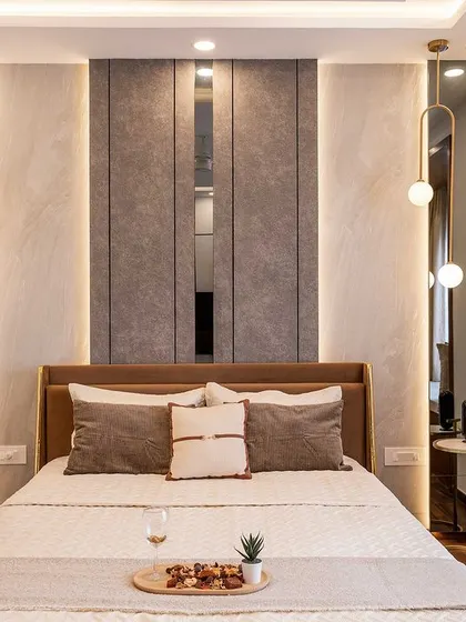 A close-up of the sophisticated headboard design, which combines different textures and integrated lighting for a hotel-like feel.