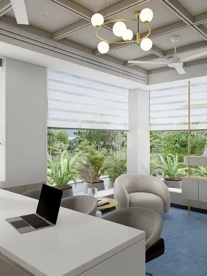 A design concept for an MD cabin surrounded by lush greenery. The space is designed to feel open and connected to the outdoors, with a calm blue carpet and light, modern furniture.