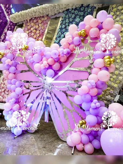 A beautiful butterfly-shaped photo prop made from wood and balloons, creating a perfect spot for guests to take pictures.