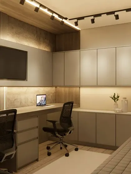 A side view of the dual-person home office, showing the depth of the desk and the extensive storage capacity of the custom-built cabinets.