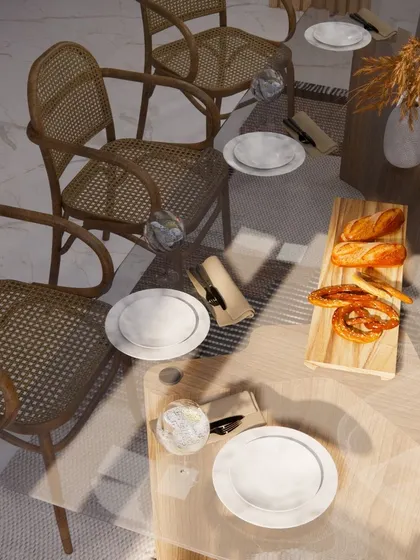 An aerial view of the 'Wicker World' dining setup, showcasing the beautiful texture of the wicker chairs and the simple elegance of the tablescape.