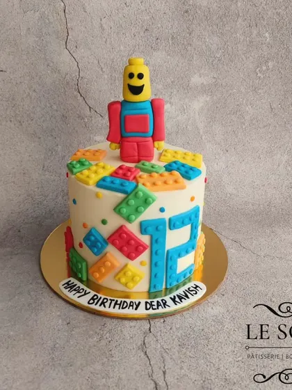 Legoooo. This 1 kg Chocolate Truffle cake is perfect for a Lego fan, with colorful fondant Lego bricks and a minifigure on top of a buttercream base.