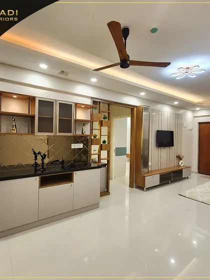 An open-concept living area featuring a stylish bar and crockery unit with a geometric gold-tinted mirror backsplash. The design seamlessly connects the living room, dining space, and entryway for a spacious feel.