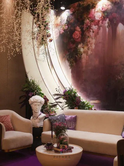 Another angle of the artful lounge, showing the interplay between the classical bust, the modern furniture, and the romantic, painterly backdrop.