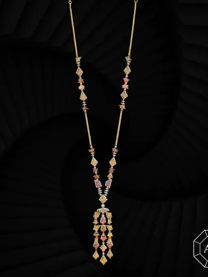 This elegant 18k gold lariat necklace is adorned with vibrant multi-cut sapphires and delicate round diamond accents.