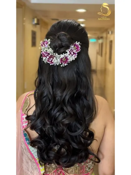 Soft curls paired with a half-up bun create a dreamy combination. I used a floral piece with purple flowers and baby's breath to complete this romantic look.
