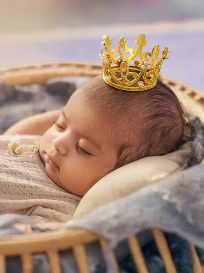 A close up on the little prince. The tiny, detailed crown is the perfect accessory for this royal-themed newborn shot.