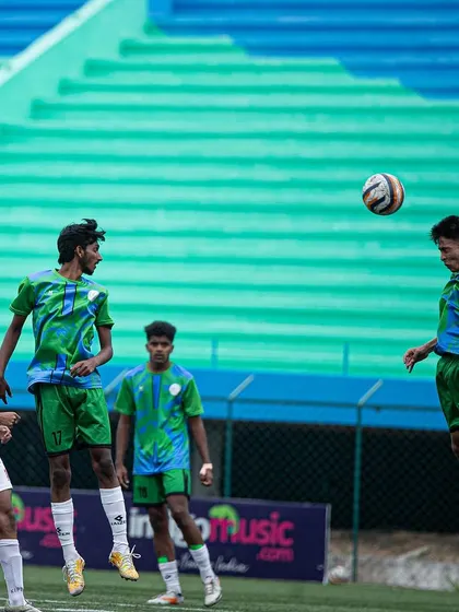 An intense aerial challenge, showing the commitment of players from both teams.
