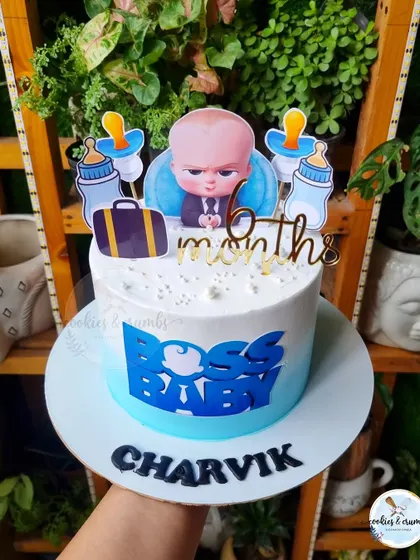 A Boss Baby themed cake for a 6-month birthday celebration. This design uses printed toppers and a blue ombre effect for a fun and graphic look.
