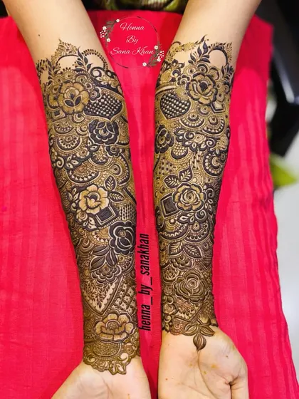 A full-sleeve bridal design where floral patterns are interwoven with geometric jaali work, creating a rich and textured effect up to the elbows.