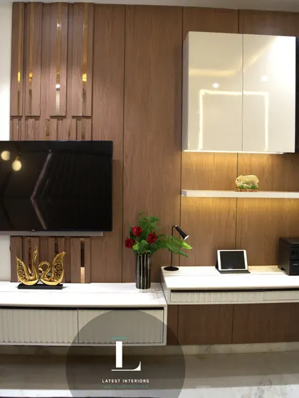 This image showcases a multi-functional wall unit that combines the TV panel with a compact study desk and display shelves. It's a perfect solution for optimizing space in a modern bedroom.