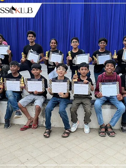 Another proud group of our student winners, holding their certificates and trophies high. We celebrate every achievement, big or small, within our chess family.