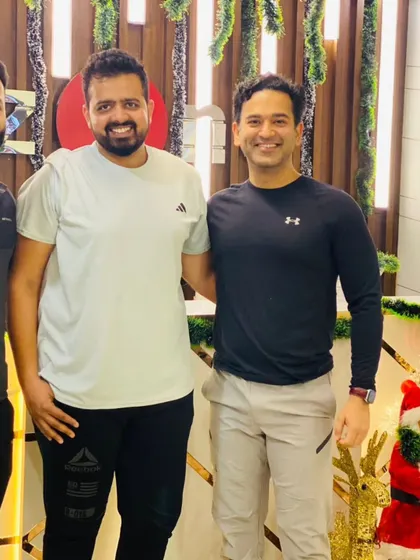 Three friends and members of our community sharing a smile and celebrating the holiday season after a workout.
