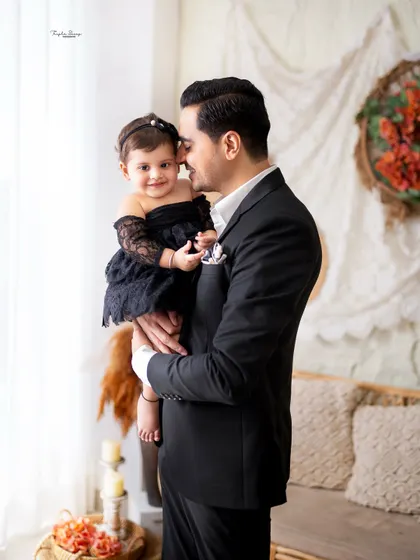 A father's gentle love for his baby girl. This touching portrait captures the sweet and tender bond between a dad and his daughter.