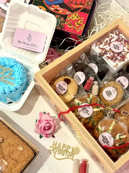 A complete Rakhi celebration in a box. This view shows how you can combine a larger hamper with a custom bento cake for an extra special touch. I love creating these personalized combinations for your celebrations.
