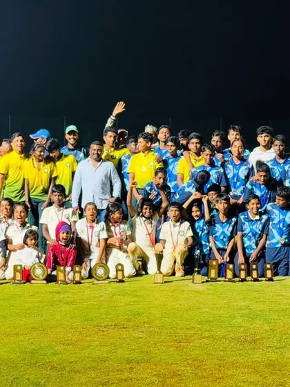 A large group photo of all participants, coaches, and officials from the RSCA vs SST Academy tournament, celebrating the spirit of cricket.