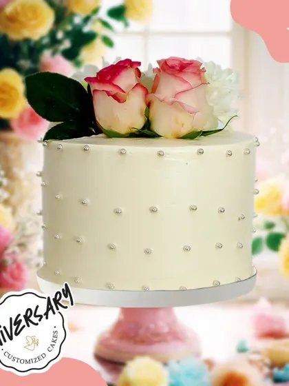 A simple and elegant anniversary cake for Mr. and Mrs. Routela in Greater Kailash. The classic white frosting with pearl details and fresh roses on top speaks of timeless love.