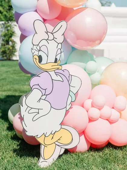 A Daisy Duck cutout adds another beloved character to the magical Disney party scene.