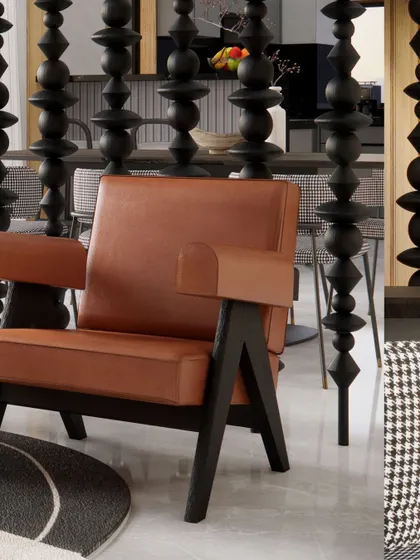A close-up of the Pierre Jeanneret-style armchair, a classic piece of modern design that signals the project's commitment to quality and timeless style.