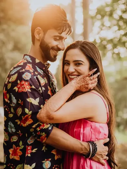 A sun-kissed pre-wedding portrait. The warm light and the couple's happy embrace make for a perfect, romantic memory.