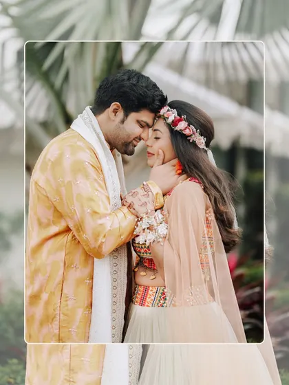 An intimate close-up of the couple, their foreheads touching, capturing a quiet moment of connection amidst the Haldi festivities.