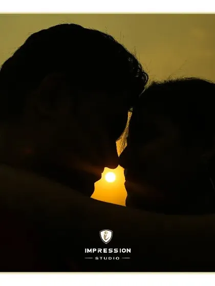 A classic sunset silhouette. This artistic shot uses the golden light to create a timeless and romantic image, focusing on their embrace and the beautiful shape of their connection.