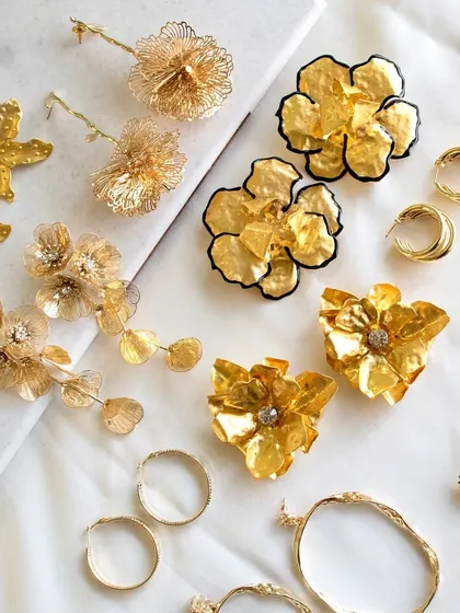 Making 'extra' look effortless. A stunning flat lay of my most popular statement earrings, from metallic florals to wildflower tassels.