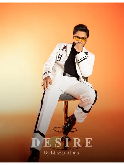 Another seated pose, this time with a thoughtful expression. The suit is versatile enough for both playful and serious moments.