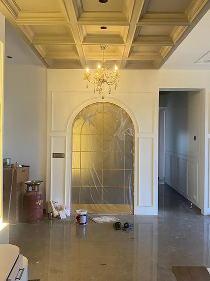 Nearing completion: The walls are painted, the coffered ceiling is finished, and the chandelier is installed. The space is ready for its final furnishings.