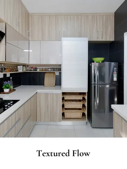 This kitchen celebrates the interplay of wood-textured finishes, matte black surfaces, and sleek lines, with clever pull-out drawers for ultimate organization.
