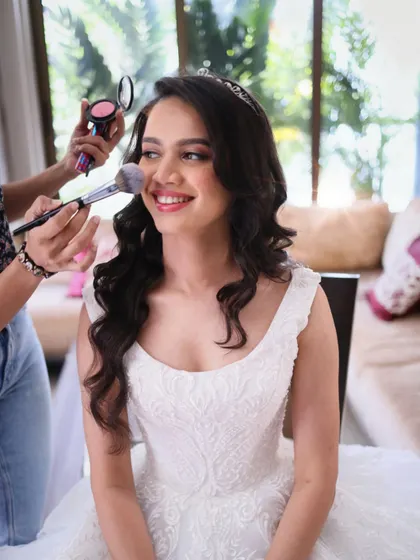 Another angle of me adding the final touches. A light dusting of powder ensures the makeup stays perfect all day while maintaining a natural, skin-like texture.
