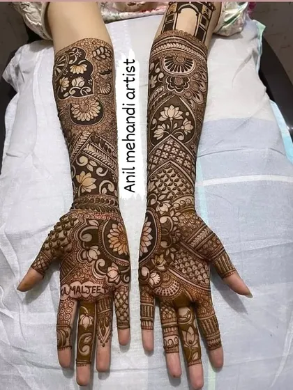 The name 'Amaljeet' is beautifully integrated into the intricate floral pattern on the palm. I can hide names or dates within the design as a special secret for the couple.