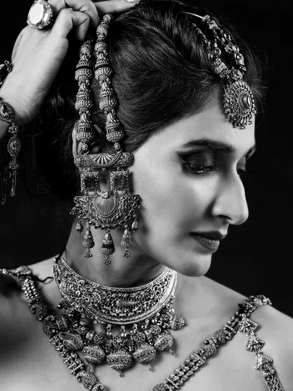 A close-up black and white shot focusing on the eye makeup and the stunning detail of the choker and earrings. This demonstrates my skill in creating makeup that is impactful even without color.
