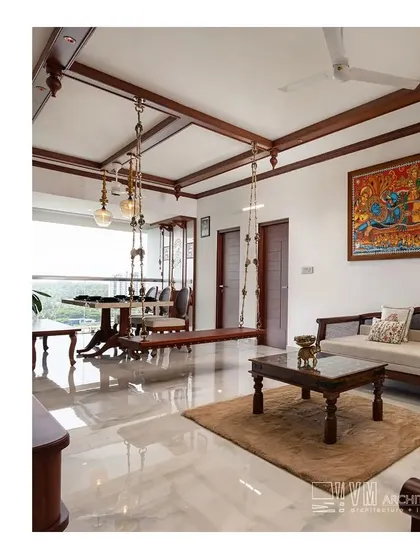 This apartment living room in Kozhikode features a traditional wooden swing ('oonjal') and classic furniture, bringing a touch of heritage and elegance to a modern home.