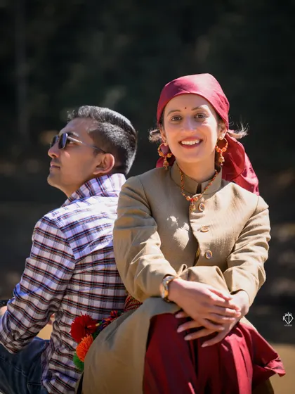 A bright, sunny portrait of the couple. She looks directly at the camera with a warm smile, showcasing the happy and welcoming spirit of a Pahari photoshoot.