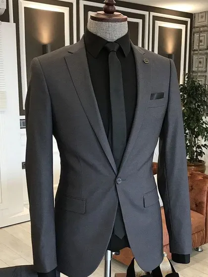 A charcoal grey suit paired with a black shirt and tie for a sleek, monochrome look. This is a very modern and powerful formal outfit.