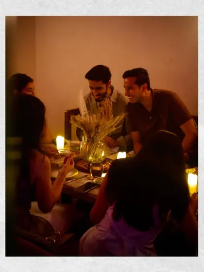 Guests enjoying the candle-lit ambiance of our private menu tasting. These intimate gatherings are where I test my most creative ideas.