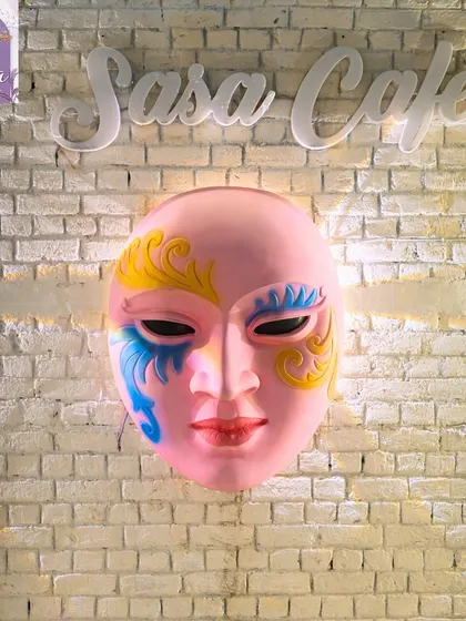 Another shot of our iconic mask wall art, which adds a touch of mystery and art to the space.