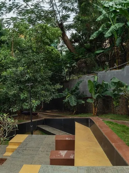 **Nepean Greens, Mumbai:** An elevated view shows how the stepped plaza is carved into the landscape. The design respects the natural slope of the site while creating functional and beautiful platforms for community use.
